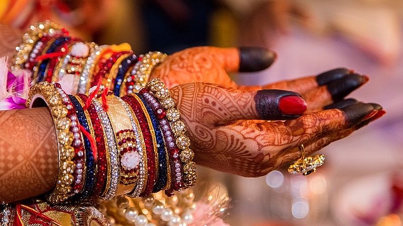 hands of an indian woman with applied mehendi 