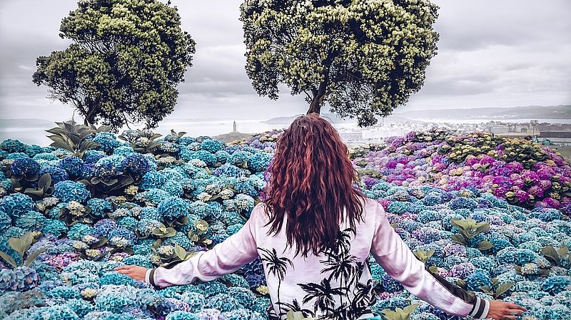 woman walking through an imaginary field of flowers
